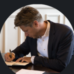 man writing on a desk